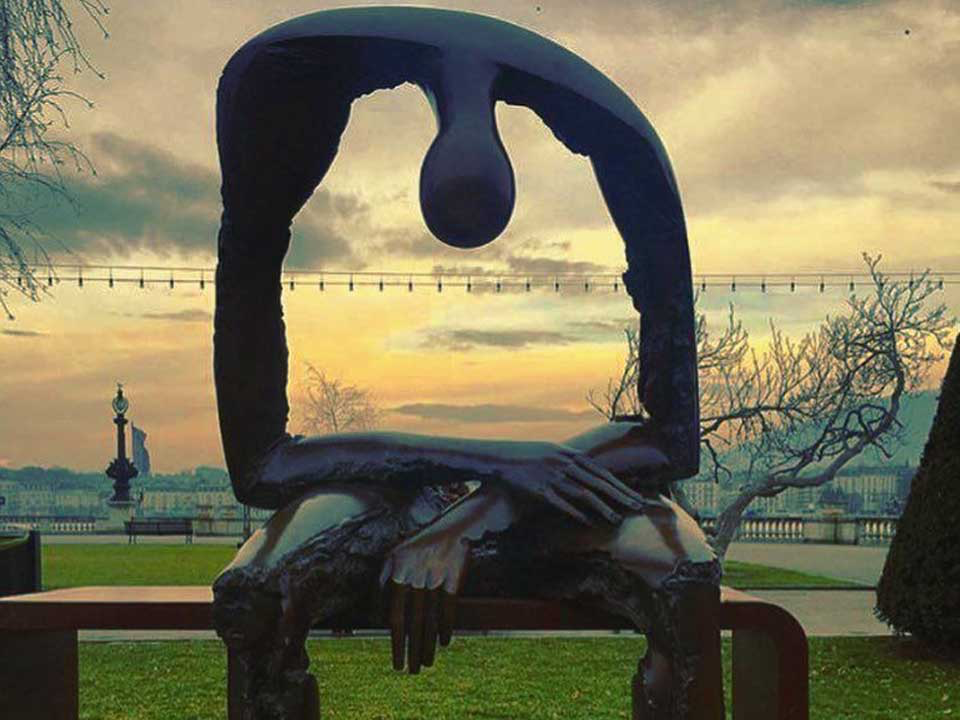 Sculpture of person hanging their head over an empty body.